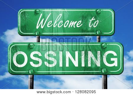ossining vintage green road sign with blue sky background
