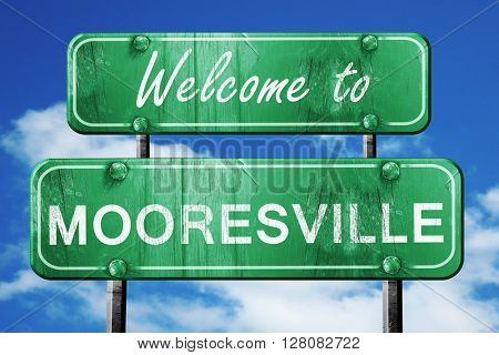 mooresville vintage green road sign with blue sky background