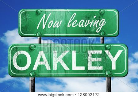Leaving oakley, green vintage road sign with rough lettering