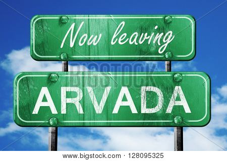 Leaving arvada, green vintage road sign with rough lettering