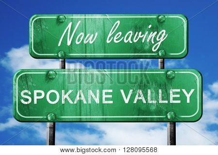 Leaving spokane valley, green vintage road sign with rough lette