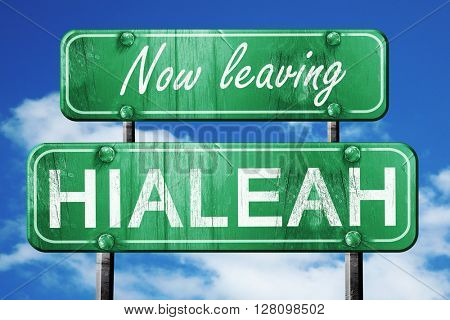 Leaving hialeah, green vintage road sign with rough lettering
