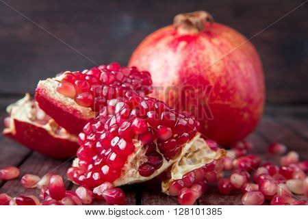 Red juice pomegranate on wooden dark background