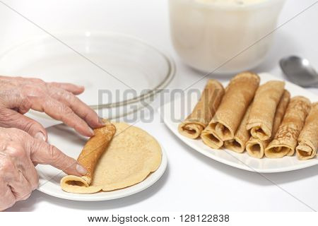 View of a woman hand rolling up a crepe