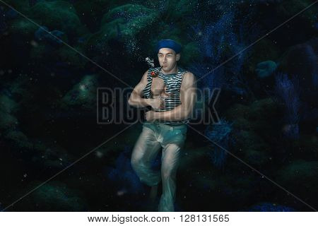 The man the ship's boy under water with a pipe in a mouth.