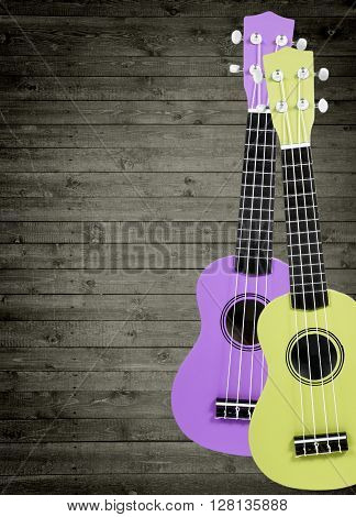A number of acoustic guitars in the background. Write text.