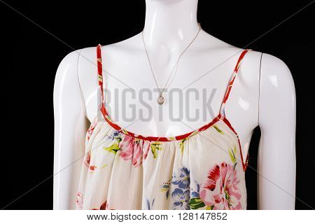 Floral pattern sarafan and necklace. Sarafan with necklace on mannequin. Woman's accessory of high quality. Brand new jewelry on sale.
