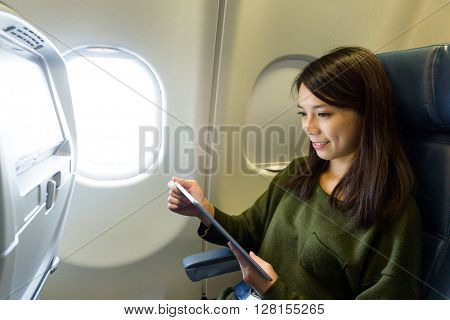 Woman use of tablet pc at plane