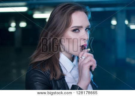 pretty woman smoking e-cigarette , shisha in the carpark