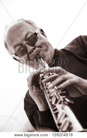 musician, trumpeter playing the instrument at sunset