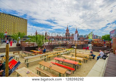 BERLIN, GERMANY - JUNE 06, 2015: Public and beautiful square where people can eat and talk, behind oberbaumbrucke,