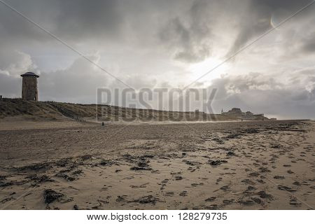 Water old tower in the dunes by the sea.