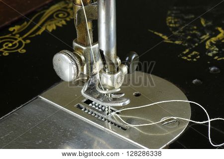Kozmice Male, Poland, April 30, 2016: Private sewing workshop. Singer sewing machine, serial number Y-5.203.193. Manufactured in 1927 by Singer factory in Clydebank, Scotland. Close-up of sewing mechanism.