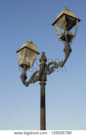 Old Fashioned Street Light against a Blue Sky