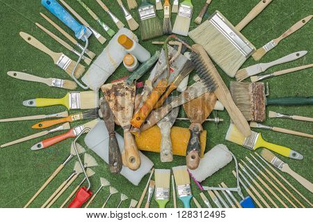 new and old brushes and spatulas , tools painter