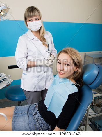 The reception was at the female dentist. Doctor examines the oral cavity on tooth decay. Caries protection. doctor puts the patient an anesthetic injection. close-up of the patient's mouth and squirt.