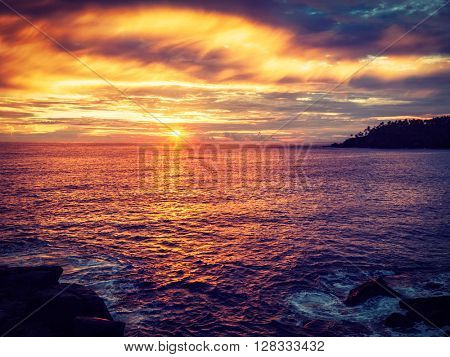 Vintage retro effect filtered hipster style image of romantic ocean sunset with dramatic sky. Mirissa, Sri Lanka