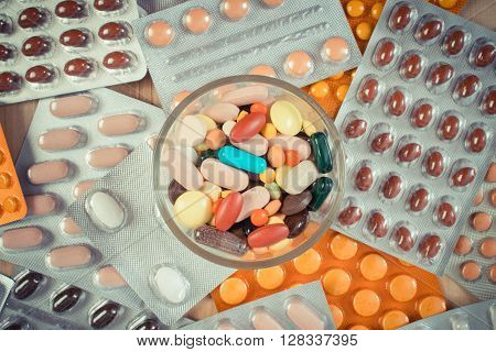 Vintage photo Colorful medical pills and capsules for therapy and blisters of tablets or supplements concept of treatment and health care