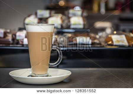 Coffee latte in tall glass served in a coffee bar
