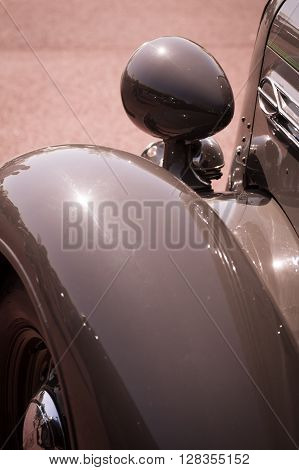 Color detail on the headlight of a vintage car.