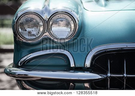 Color detail on the headlight of a vintage car.
