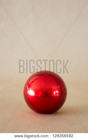 Shiny hard red ball on brown background stock phoro