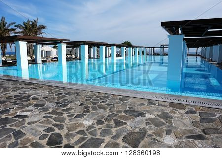 HERAKLION, CRETE, GREECE - MAY 13, 2014: The big blue swimming-pool with columns in luxury class hotel Grecotel Amirandes, May 13, 2014, Greece.