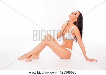 Portrait Of Pretty Laughing Woman Sitting In White Lingerie
