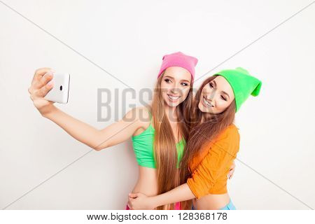 Pretty Women With Beaming Smiles Making Selfie On Smartphone