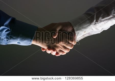 Two Businessman Handshake Handshaking between darkness and light
