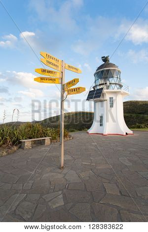 Cape Reinga Lighthouse in New Zealand with signpost.