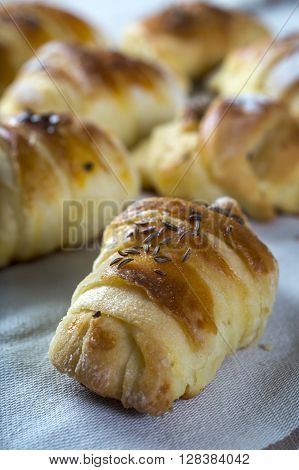 Mini croissants filled with cheese on wooden table
