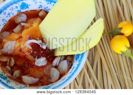 Mango and side dishes on  wood texture background