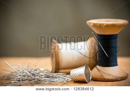 two spools of thread with thimble, shallow depth of field