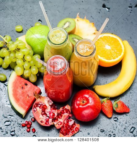 Fresh Juices Smoothie Three Bottles made Red Green Orange Fruits Water Melon Strawberry Apple Kiwi Grapes Orange Mango Pomegranate Tropical Selective focus Square