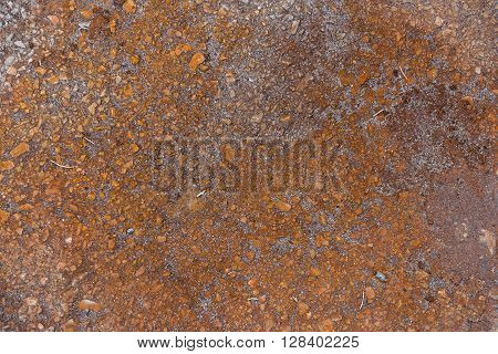 Rust steel surfaces and cracks of the asphalt road.