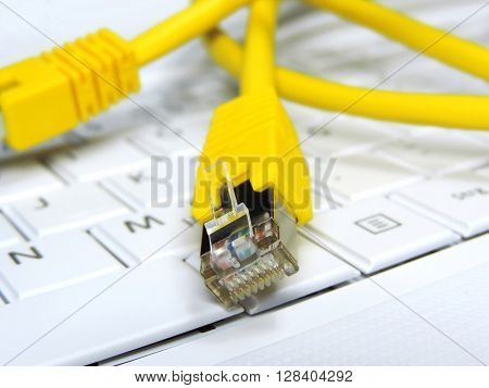 High speed internet connection. Computer cable on a computer keypad.