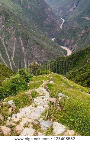 South America - Choquequirao lost ruins (mini - Machu Picchu) remote spectacular the Inca ruins near Cuzco. Cultivated terrace fields on the steep sides of a mountain