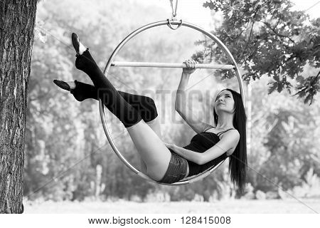 beautiful girl on the hoop on nature background