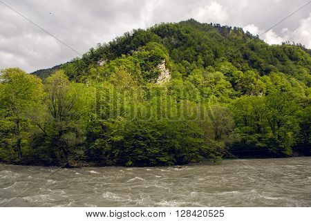 rapid mountain river in Abkhazia in the spring morning, with mountains