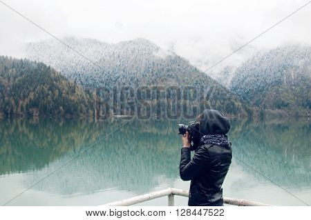 girl in a leather jacket with a camera taking pictures Ritsa lake in the spring morning, with clouds and blue water
** Note: Visible grain at 100%, best at smaller sizes