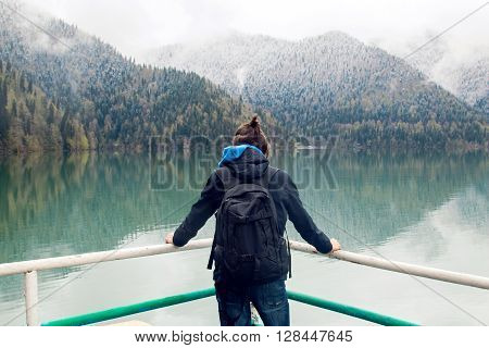 guy with the ponytail while wearing a backpack and jacket stands back and looks forward Ritsa lake in the spring morning
** Note: Visible grain at 100%, best at smaller sizes