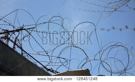 Barbed wire stretched along the brick walls