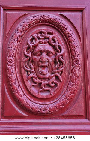 Detail of an old door in Paris representing the gorgon Medusa