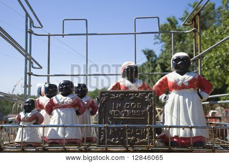 Collection of Aunt Jemima statuettes outdoors.