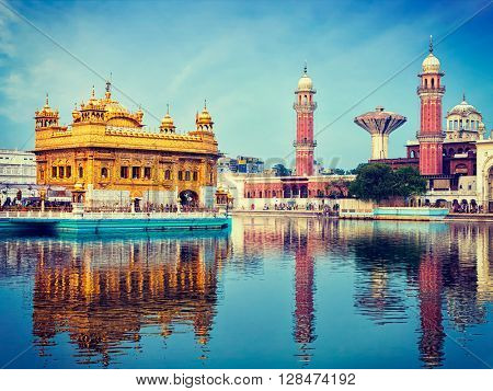 Vintage retro effect filtered hipster style image of famous indian toursit landmark and sacred pilgrimage site - Sikh gurdwara Golden Temple (Harmandir Sahib). Amritsar, Punjab, India