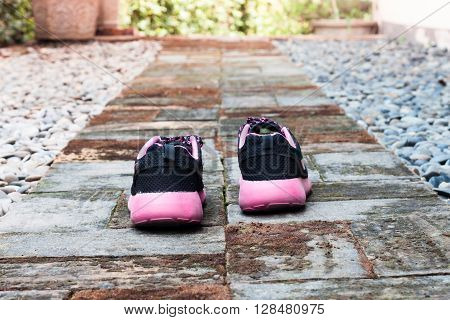 Running shoes in home garden foot path, stock photo