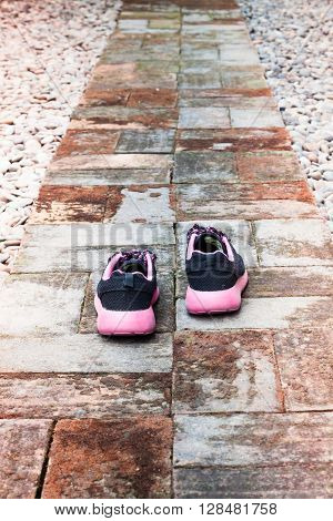 Running shoes in home garden foot path, stock photo