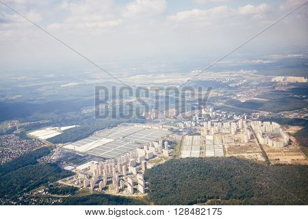 Aerial view of city from airplane that takes-off from airport.