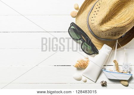 Summer holiday blackground Beach accessories on white wood table Vacation and travel items